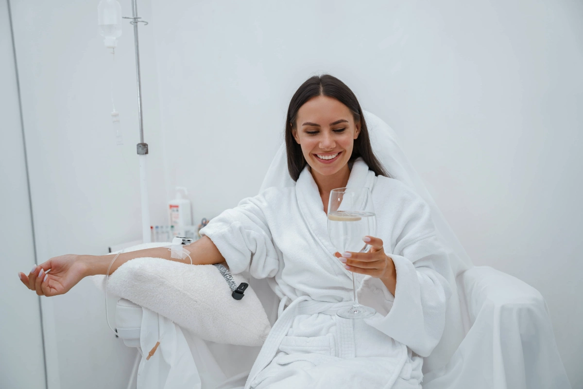 Woman receiving IV Therapy in Davie, FL while relaxing in a wellness clinic chair with hydration drip treatment for recovery and energy support.
